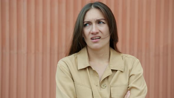 Slow Motion Portrait of Bored Young Lady Yawning Looking at Camera Standing Outdoors