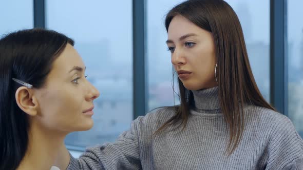 A Professional Makeup Artist Does Makeup for a Beautiful Model