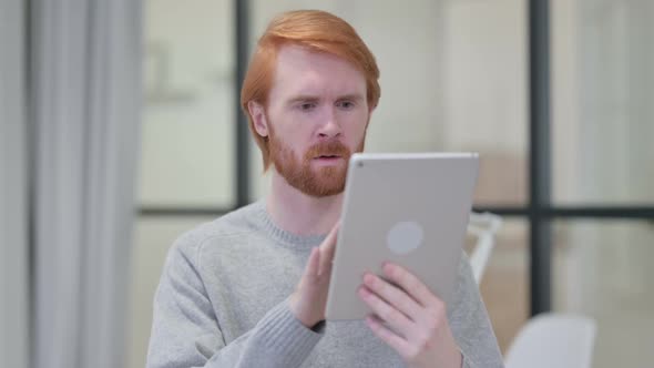 Successful Beard Redhead Man Celebrating on Tablet