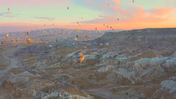 Aerial Drone View Pink Dawn in Cappadocia in the Rose Valley with Views of the Hills and Colorful