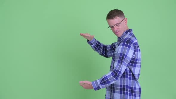 Portrait of Happy Hipster Man Snapping Fingers and Showing Something