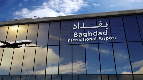 Airplane landing at Baghdad Iraq airport mirrored in terminal