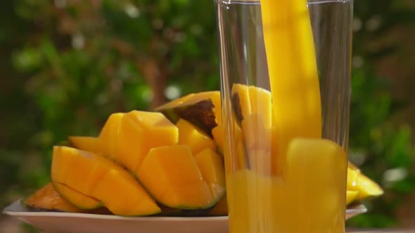 A Wave of the Fresh Mango Juice Poured in a Tall Glass