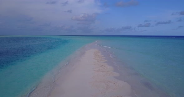 Luxury drone tourism shot of a white sandy paradise beach and blue water background in high resoluti