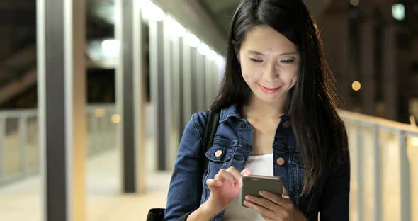 Woman Reading on Mobile Phone 