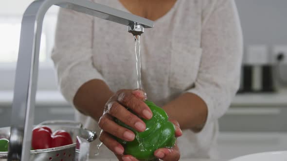 A senior african american woman spending time at home and cooking social distancing in quarantine.