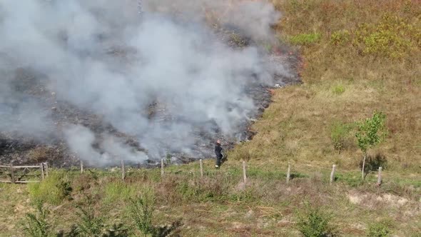 Firefighter on meadow fire. Air footage