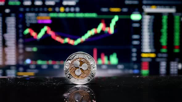Coin Ripple XRP on background cryptocurrency trading chart on computer screen