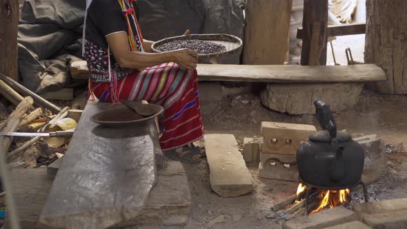 A karen tribe woman hands holding roasted coffee bean on threshing basket