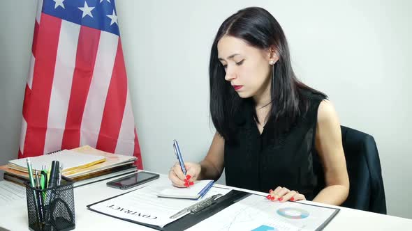 Businesswoman Reads A Contract At The Office