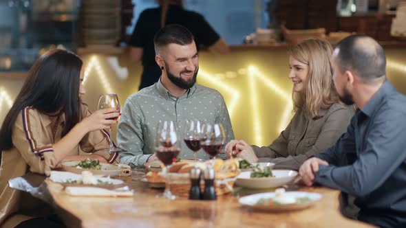 Hipster Bearded Male Telling Something Surrounded By Group of Friends