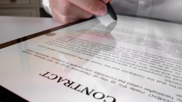 Man sign signature on digital contract at tablet computer in close up view.