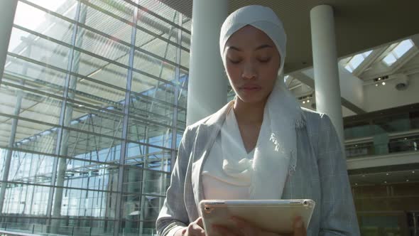 Businesswoman using tablet in modern office building