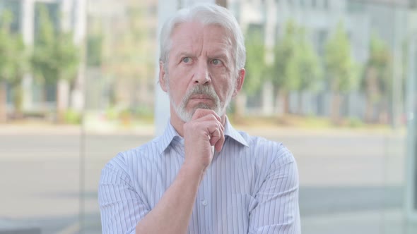 Portrait of Pensive Old Man Thinking Outdoor