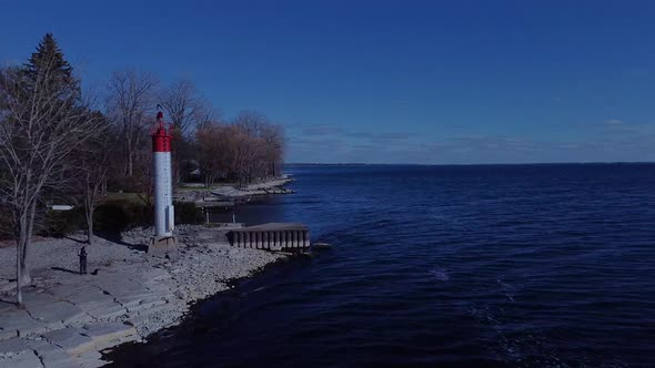 Aerial of a waterfront with a tiny lighthouse