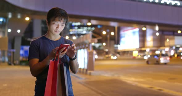 Man Use of Mobile Phone in The Street at Night