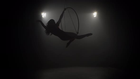 Young Girl Performs the Acrobatic Elements in the Air Ring