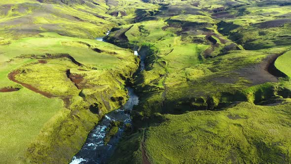 Flying Above the Vibrant Green Lava Flows Covered With Moss and the River Skogar, Iceland