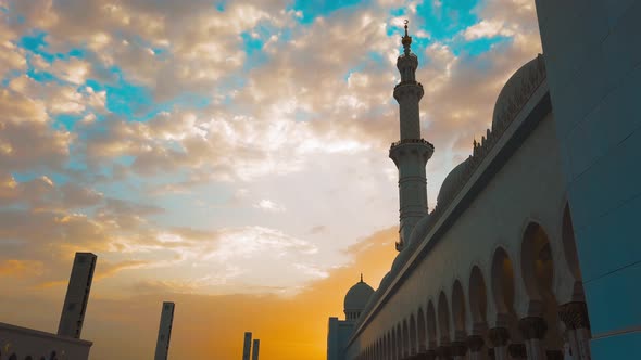 A Young Girl Walks Into a Mosque at Sunset
