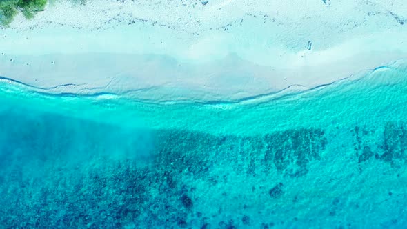 Aerial flying over travel of tropical shore beach voyage by blue lagoon and white sand background of