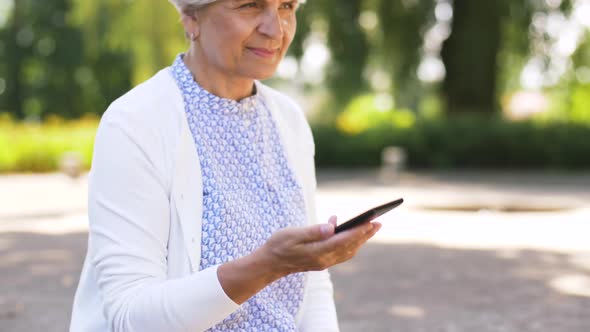 Senior Woman Calling on Smartphone in Park 27