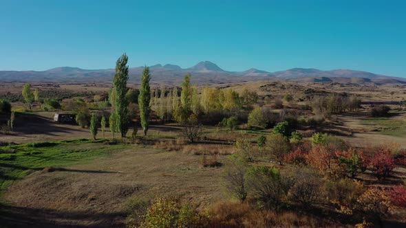 Aerial Drone Shot Right To Left of Fields and Trees on Background of Mount Aragats