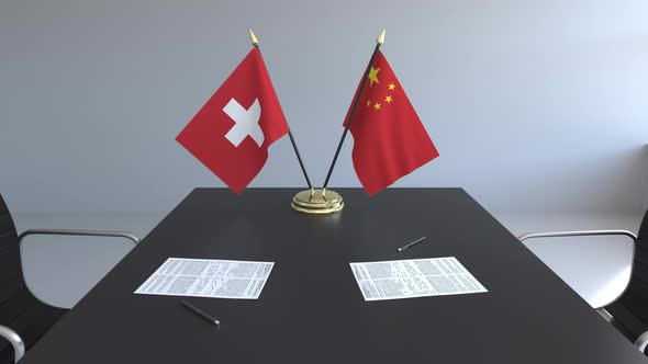 Flags of Switzerland and China and Papers