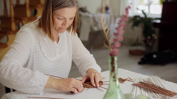 Mature Woman Making Paper Vine Basket at Home