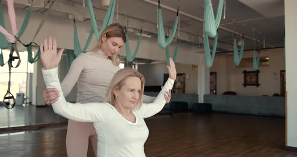 Pregnant Woman and Her Personal Trainer Doing Stretching Exercises