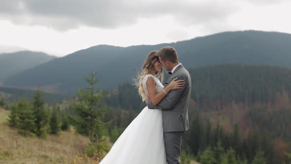 Lovely Young Newlyweds Bride Groom Embracing on Mountain Slope Happy Wedding Couple Family in Love