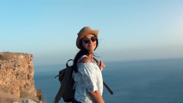 Hipster Travel Female Having Fun Smiling Walking on Top of Mountain Over Sea at Sunset