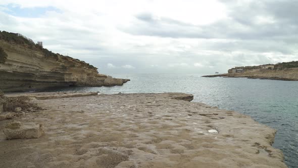 Plateau of Il-Kalanka Beach in Malta with Splashing Turquoise Colour Water in Bay