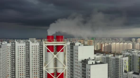 Aerial Drone Pan Shot of Industrial Tubes on Background of Houses in Moscow