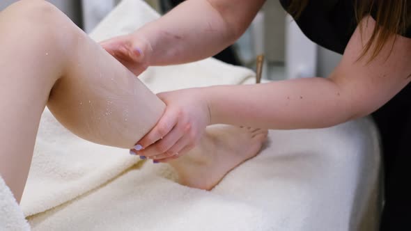 Woman Having Feet Massage in Beauty Spa Salon Close Up