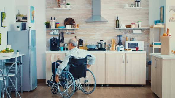 Handicapped Man Opening Refrigerator