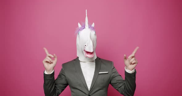 Happy Guy in Gray Suits Dance with Unicorn Mask