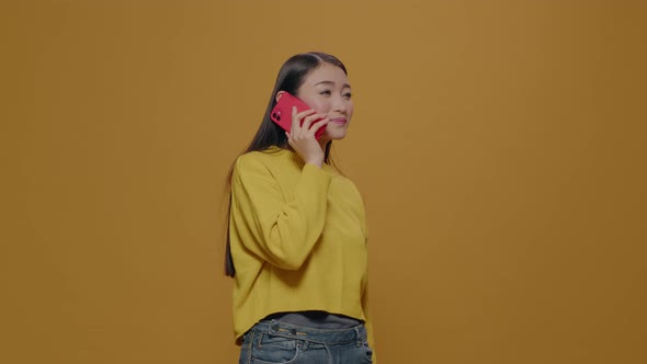 Asian Woman Using Smartphone to Have Phone Call Conversation