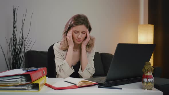 Tired woman, overwhelmed by laptop work