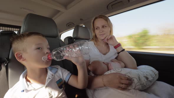 Mum with two children having car journey