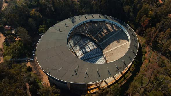 Aerial top down dolly out of Quinta Vergara Amphitheater and Park surrounded by forest, Viña del Mar