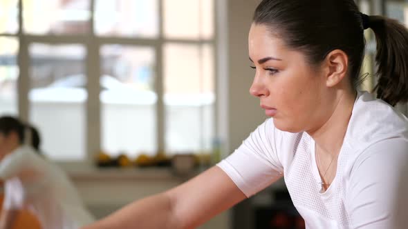 Profile of a Girl Who is Doing a Difficult Exercise with Ropes