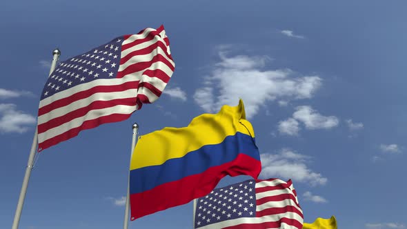 Flags of Colombia and the USA Against Blue Sky