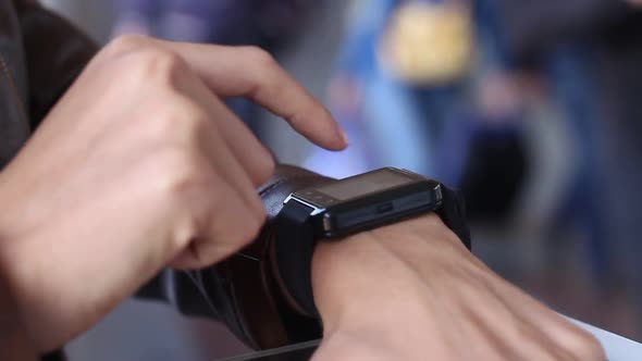 Woman Uses A Smart Black Smart Watch In The Room