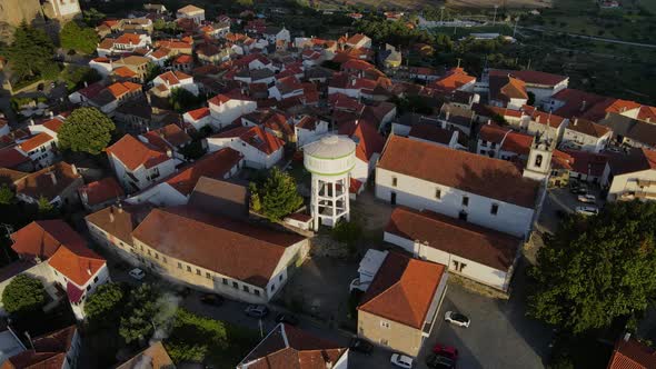 A drone circles the water tower of the old town in Belmont Portugal.