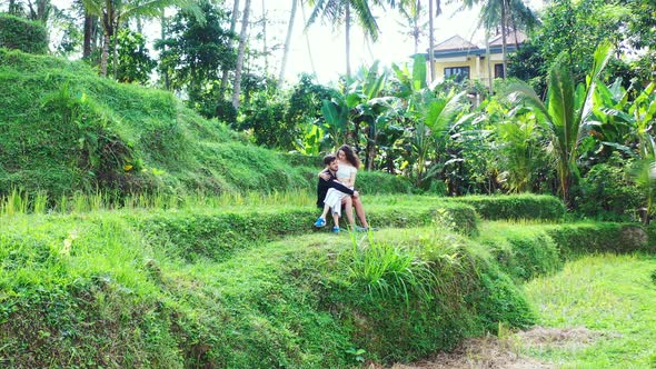 Thailand Agicultural Land Showing A Man Carrying His Woman On His Lap While Enjoying The Beauty Of T