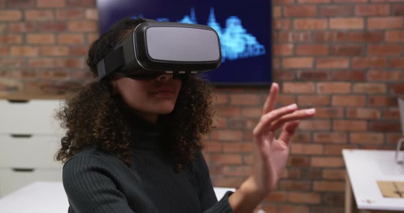 Creative businesswoman using virtual reality headset in modern office