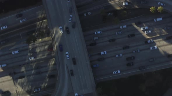 AERIAL: Birds Eye View of Downtown Los Angeles, California Intersection Traffic with Palm Trees and