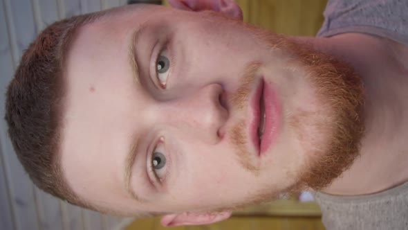 Vertical Shot Confident Redhead Man Vlogger Look at Camera Talk Using Computer App Webcam View