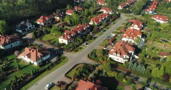 Aerial view of a new housing estate in the suburbs, camera moving right.