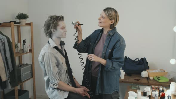 Woman Applying Zombie Makeup on Man